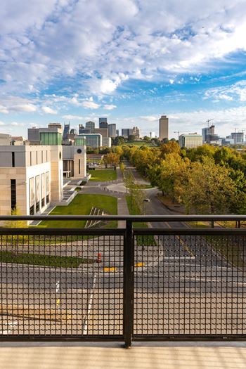A cityscape with buildings and a road in the foreground.